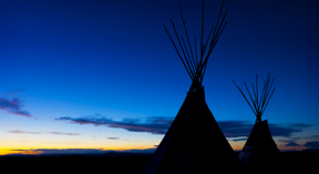 two tipis at sunset